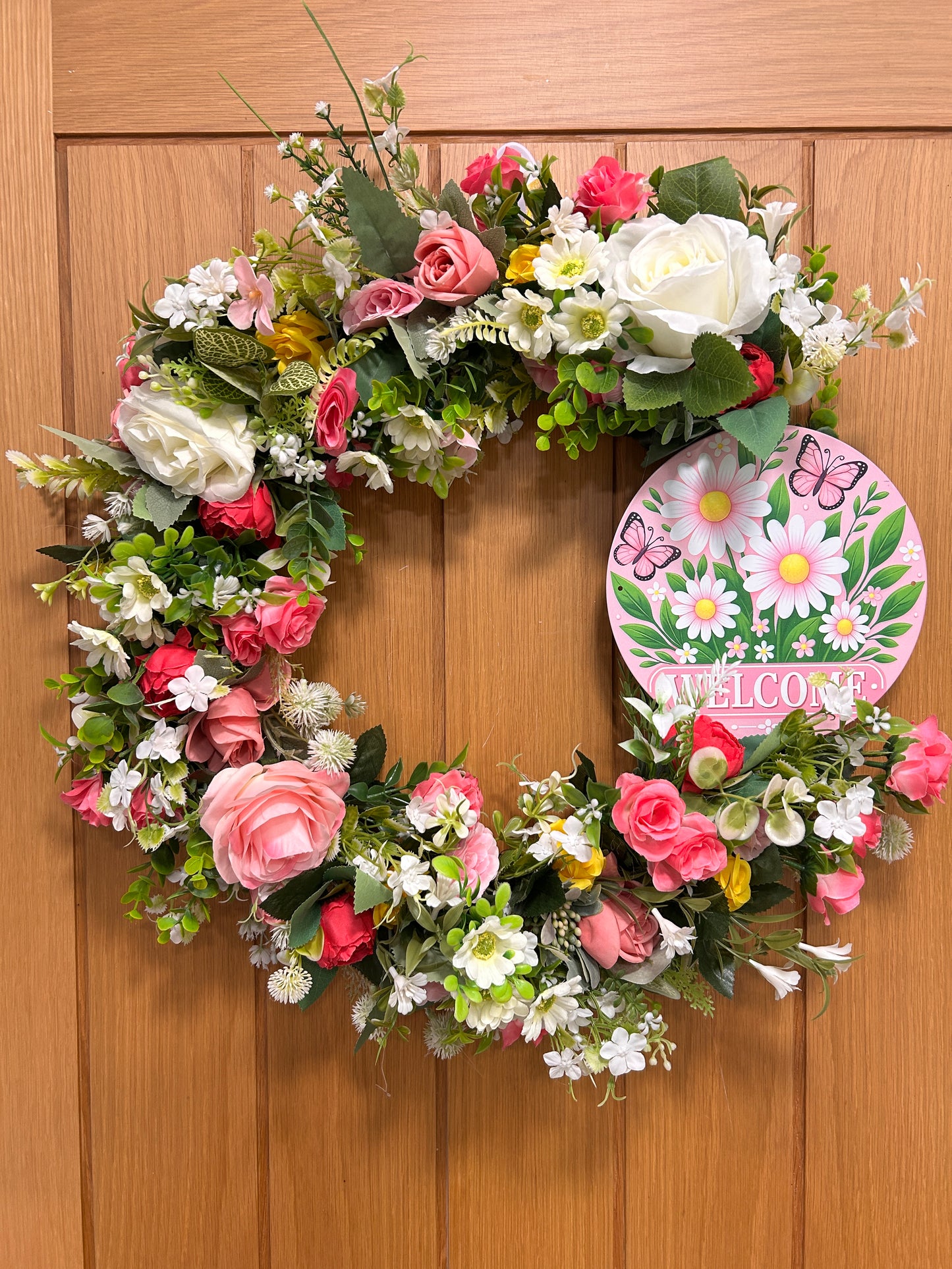 Artificial wreath with welcome sign